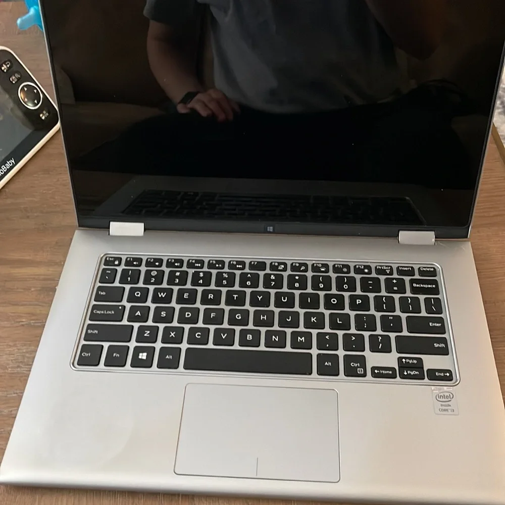 Silver Dell laptop that folds over to a tablet